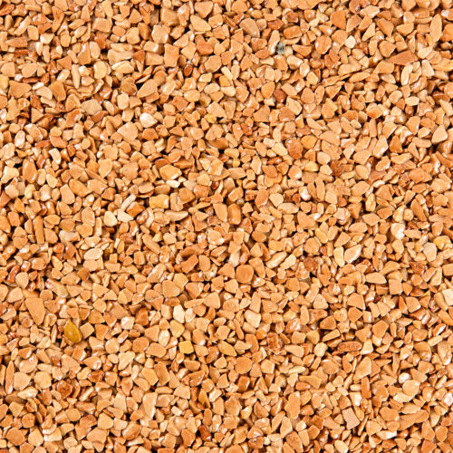 Nahaufnahme eines ockerfarbenen Steinteppichs mit gleichmäßiger Körnung